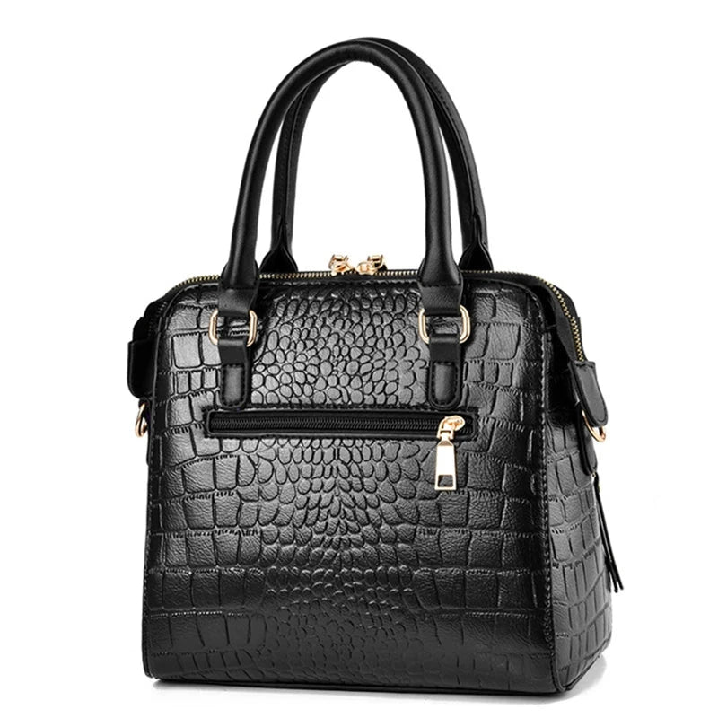 Black textured handbag with gold accents on a white background, featuring the brand 'Yogodlns'.