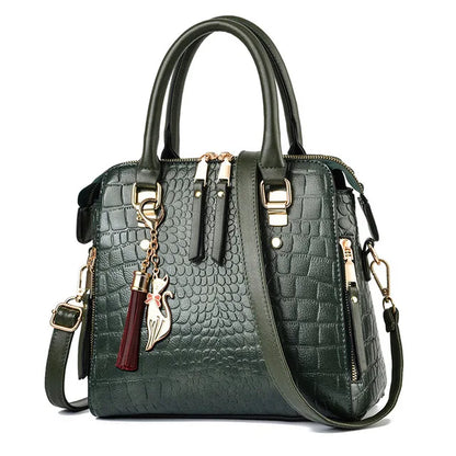 Green textured handbag with gold accents and a tassel on a white background