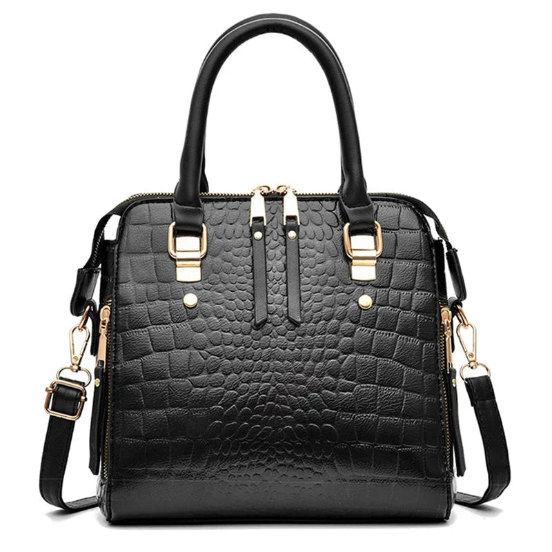 Black textured handbag with gold accents on a white background, featuring the brand 'Yogodlns'.