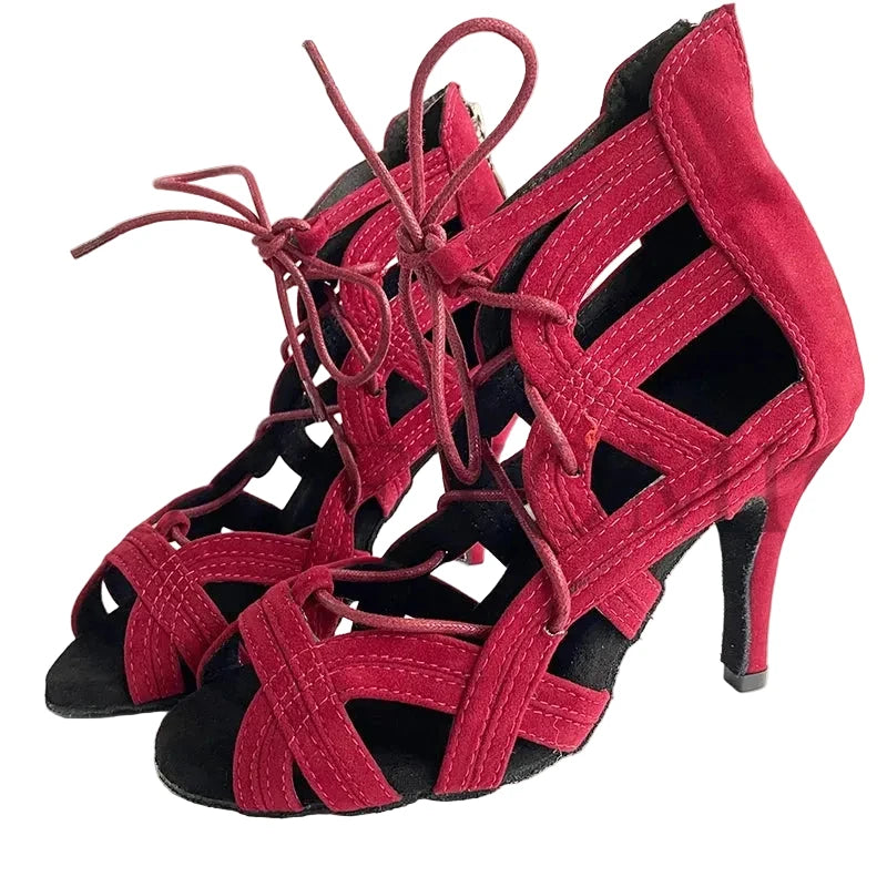 A pair of women's high-heeled sandals in a deep magenta-red suede-like material with matching lace-up front straps and black soles, shown on a plain light background. The brand name 'YSWEYOMIC' is printed in the top left corner.