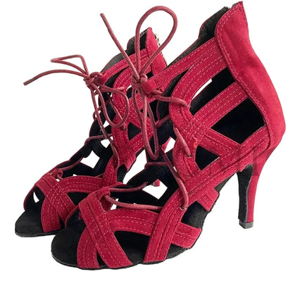 A pair of women's high-heeled sandals in a deep magenta-red suede-like material with matching lace-up front straps and black soles, shown on a plain light background. The brand name 'YSWEYOMIC' is printed in the top left corner.