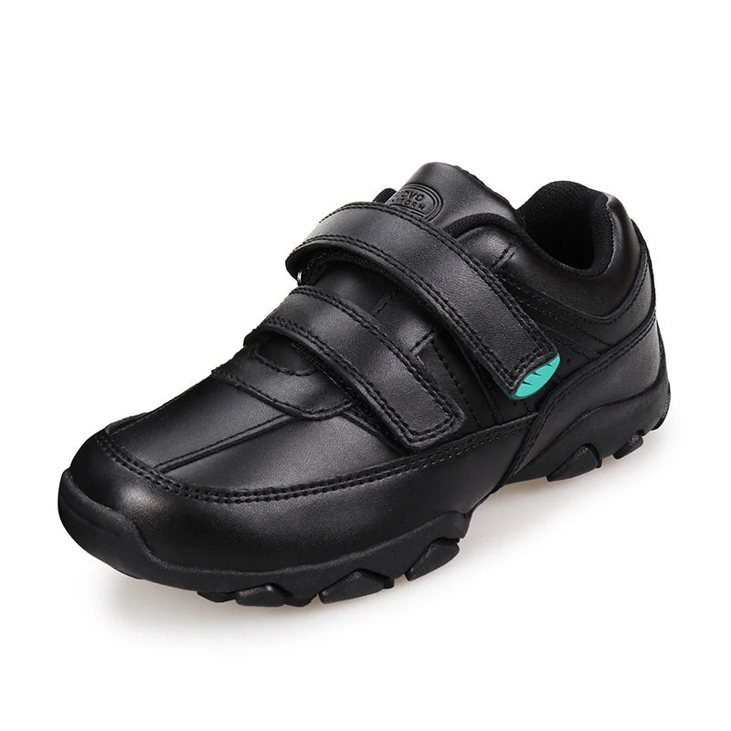 A black low-top casual shoe with two hook-and-loop straps, a small mint green accent on the side, and a rugged sole, shown on a white background with the UOVO brand logo in the top-left corner.