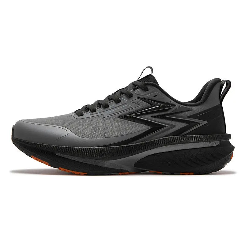 A gray and black athletic running shoe with a thick cushioned sole and subtle orange accents on the outsole, shown from a side profile on a white background.
