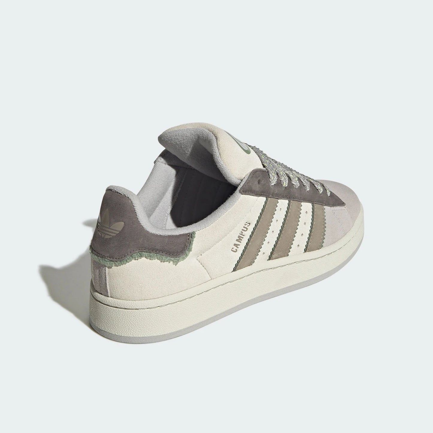 Adidas sneaker with three stripes on a light gray background