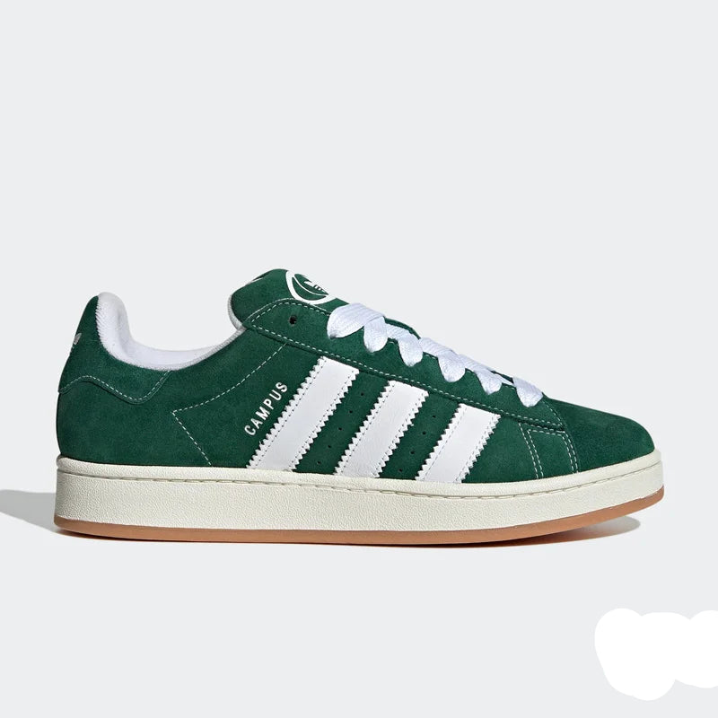 Green Adidas sneaker with white stripes on a light gray background