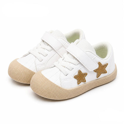 A pair of children's white low-top sneakers with hook-and-loop straps, white laces, textured beige rubber soles, and gold star-shaped accents on the sides. The PmwRun brand logo is visible in the top left, and the word 'Gold' is in the bottom right.