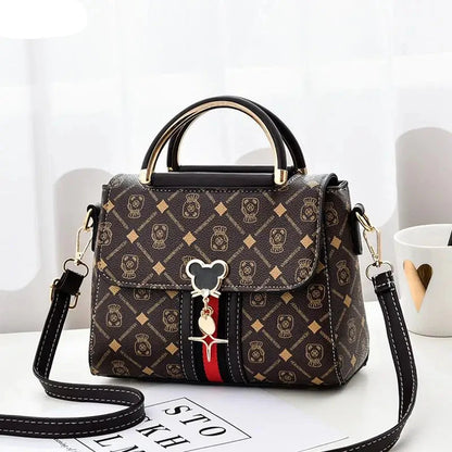 Designer handbag with a distinctive pattern and handle on a white surface.