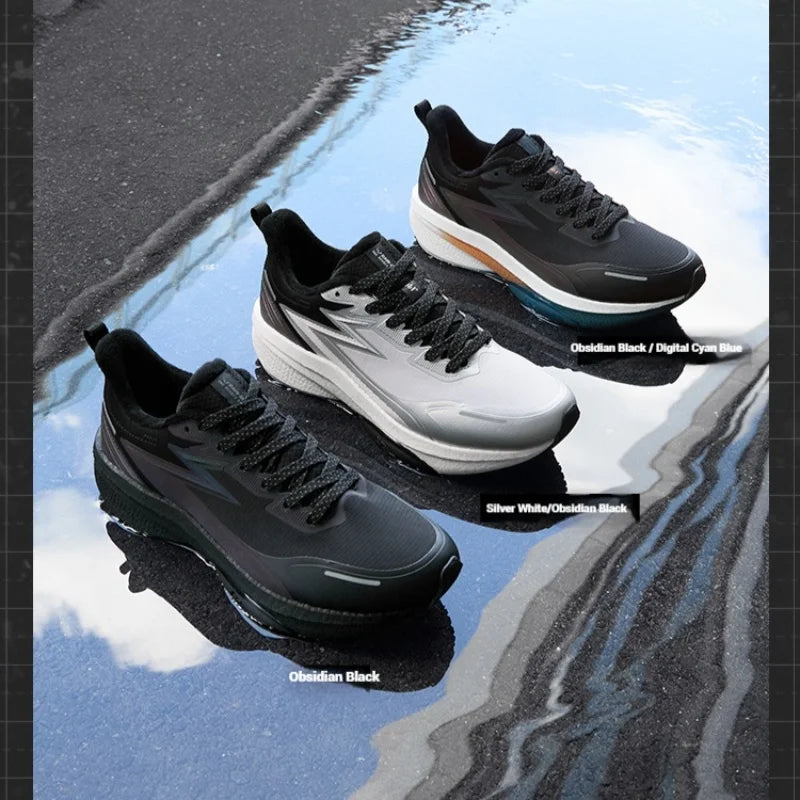 Four pairs of black and white sneakers on a reflective surface with water.