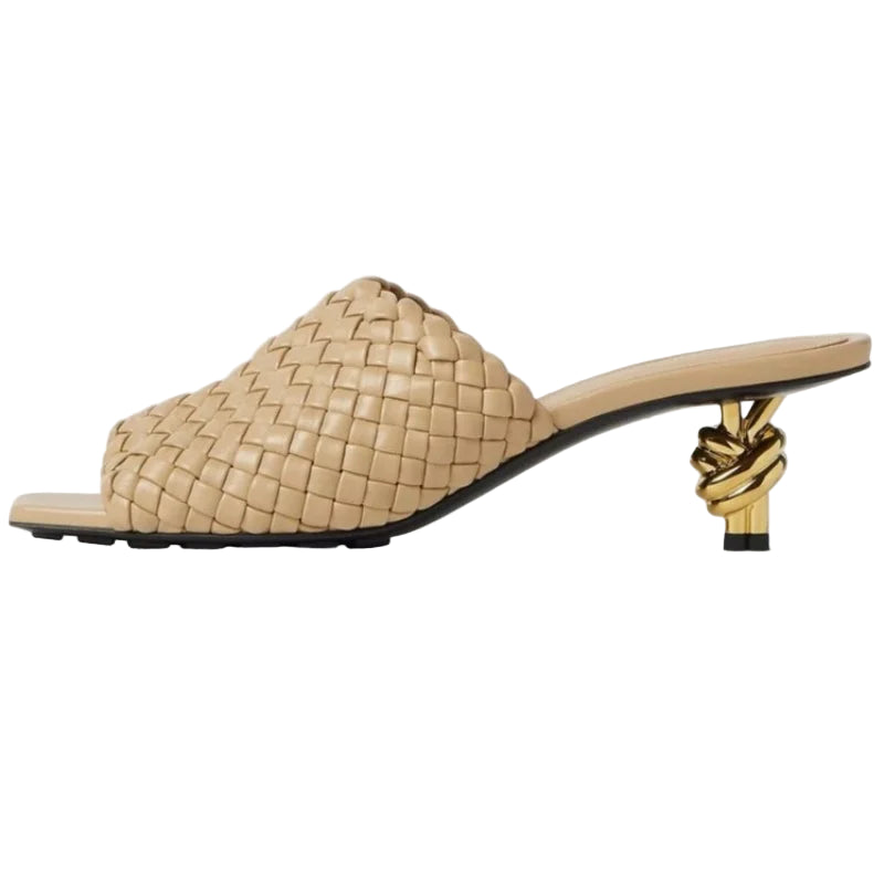 Beige woven sandal with a gold knot heel on a white background