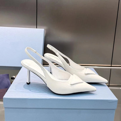 White high-heeled shoes on a light blue box with a neutral background