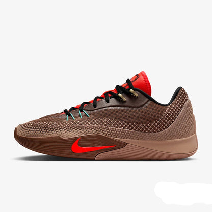 A Nike basketball shoe in brown and black with bright red accents, including the Swoosh, tongue, and laces, shown in a side profile on a light gray background.