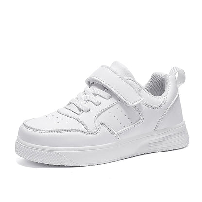 A white low-top sneaker with a hook-and-loop strap closure, lace-up front, perforated side detailing, and a thick white sole, shown on a plain white background.