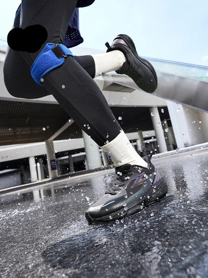 Person wearing black athletic shoes and blue knee pads on a wet surface with '361®' branding.