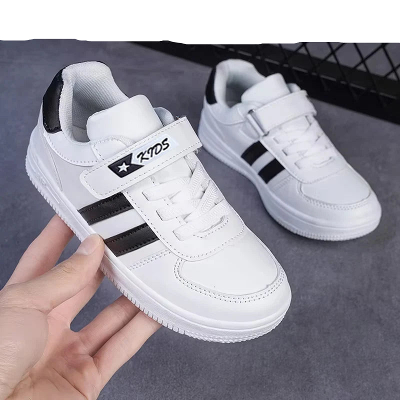 White sneakers with black stripes held by a hand on a gray surface, with 'NGBGAGA' branding.