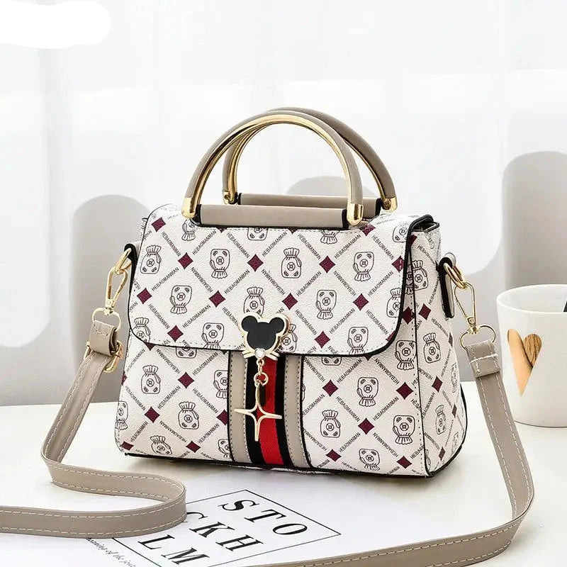 Designer handbag with brand logo on a white surface