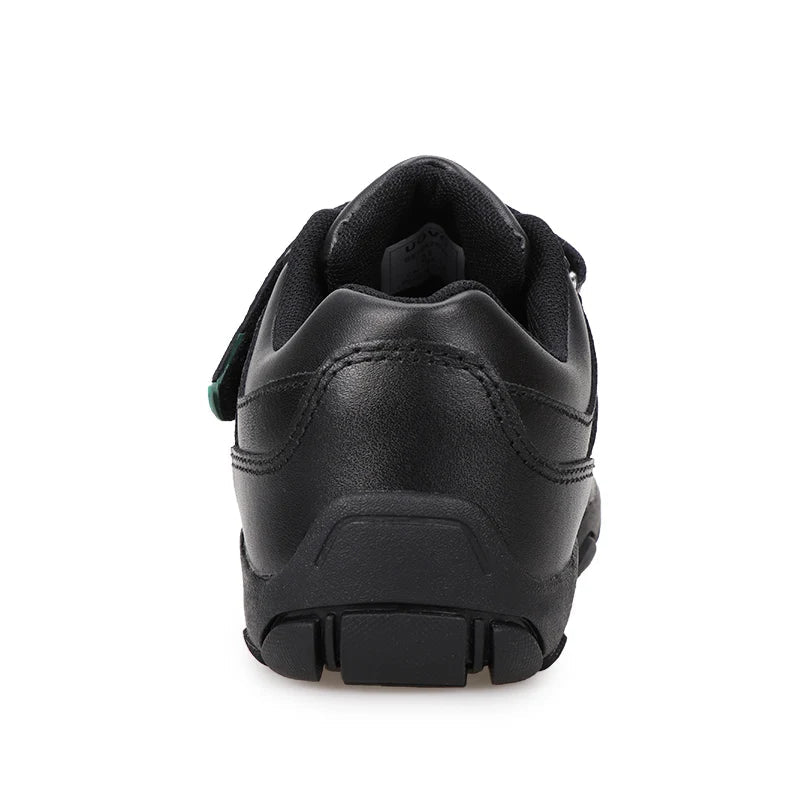 A black leather low-top sneaker shown from a rear three-quarter angle on a white background, featuring a hook-and-loop strap closure with a small green accent tab and a chunky black sole. The brand name 'UOVO' is displayed in the top left corner.