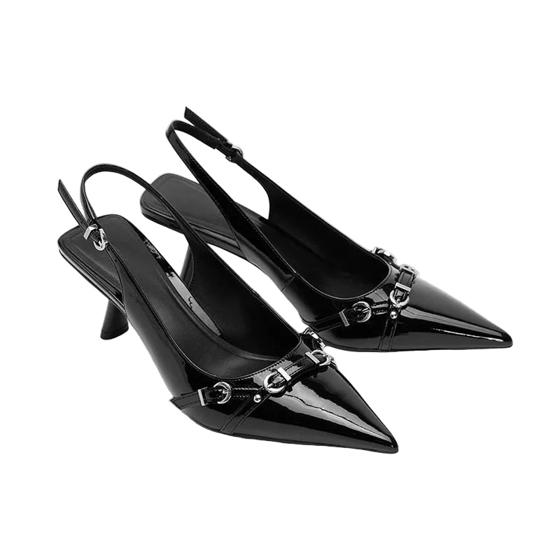 Black pointed-toe slingback heels with metallic accents on a light gray background