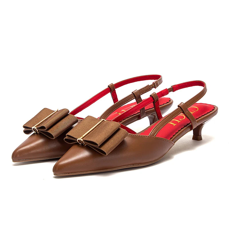 Brown high-heeled shoes with red interior and visible brand name on a white background