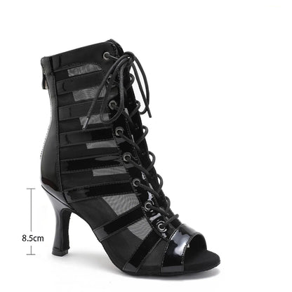 Black lace-up high-heeled shoe with suede outsole and sole detail on a white background