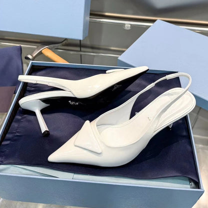 White high-heeled shoes with a bow detail in a blue box.
