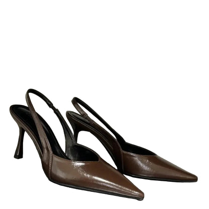 Pair of brown high-heeled shoes on a white background