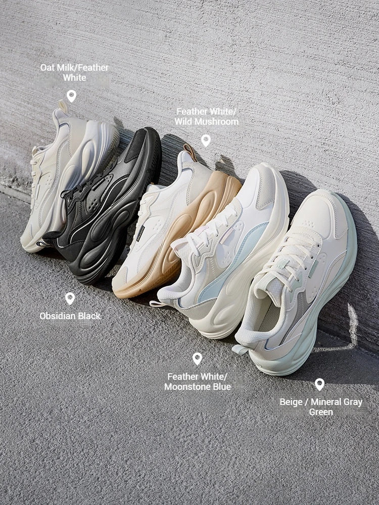 Five chunky platform sneakers arranged diagonally on a gray concrete surface, each labeled with its color variant including oat milk/feather white, feather white/wild mushroom, obsidian black, beige/moonstone blue, and beige/mineral gray green.